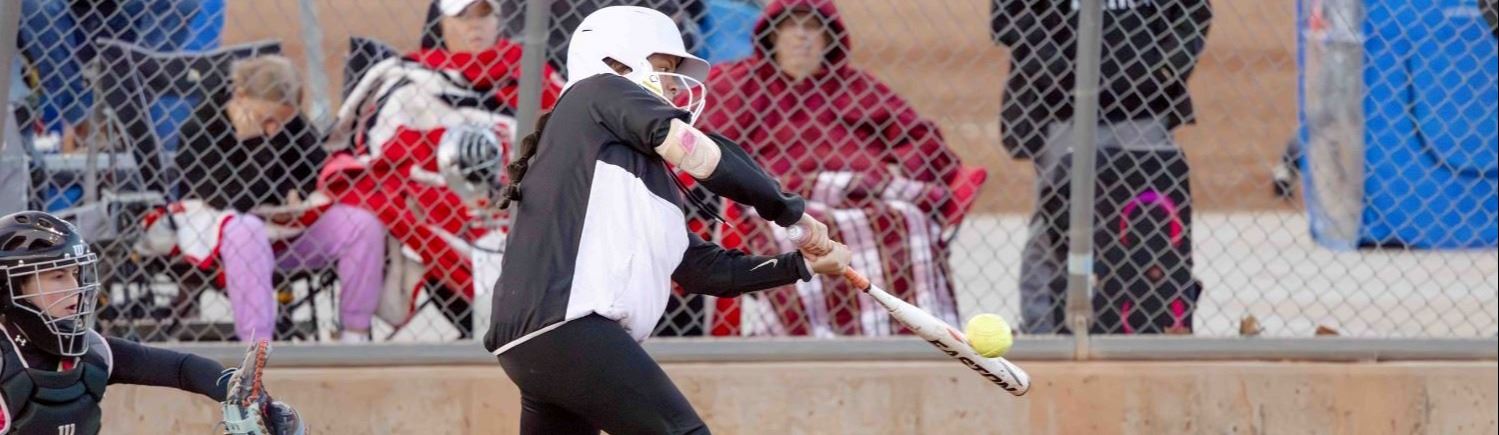 A girl batting a softball