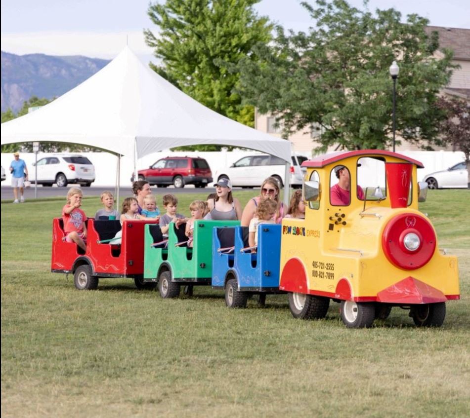 A small train ride in a grass field